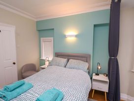 A bedroom with a bed and a side table at Falcon's Nest in Whitby