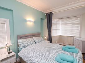 A bedroom with a bed and nightstand at Falcon's Nest Whitby