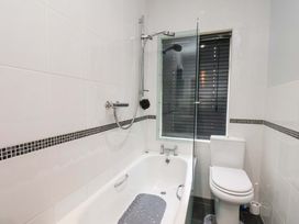 A bathroom with a bathtub and shower at Falcon's Nest in Whitby