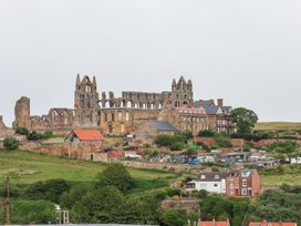 A landscape with ruins and houses at Falcon's Nest in Whitby