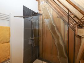 A bathroom with a shower and towel rack at Pucklechurch in Kingsteignton