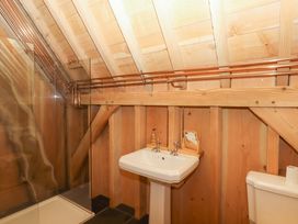 A bathroom with a shower and sink at Pucklechurch in Kingsteignton