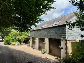 A garage with a pathway and plants at The Hayloft in Lostwithiel