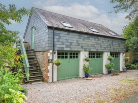 A building with garage doors and steps at The Hayloft in Lostwithiel