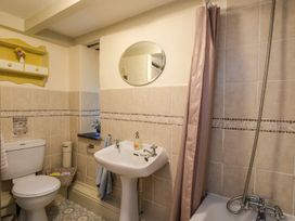 A bathroom with a toilet sink and bathtub with shower at The Mill in Lostwithiel