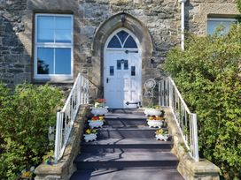 An outdoor entryway with a front door and flower pots at Ashleigh House