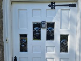 A front door with glass panels and a security device at Ashleigh House
