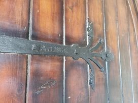 A wooden door with an iron hinge and inscription from the year 1866 at Ashleigh House