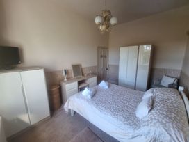 A bedroom with a bed and furniture at Ashleigh House