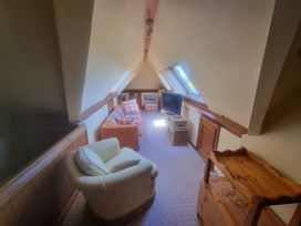 An attic with a sofa and television at Ashleigh House