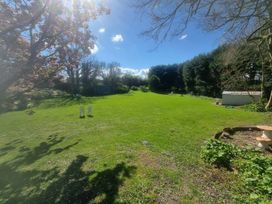 A garden with chairs and a shed at Ashleigh House in 