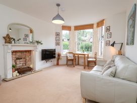 A living room with a fireplace and television at Happy Days in Scarborough
