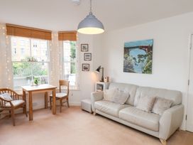 A living room with a sofa and dining table at Happy Days in Scarborough