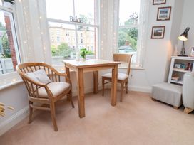 A dining room with a table and chairs at Happy Days in Scarborough