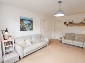 A living room with a sofa and a shelf at Happy Days in Scarborough