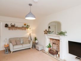 A living room with a sofa and a fireplace at Happy Days in Scarborough