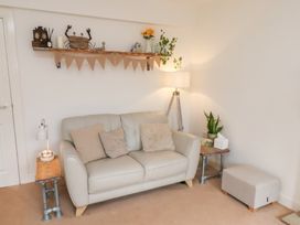 A living room with a sofa and decorative items at Happy Days in Scarborough