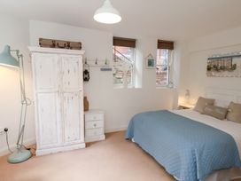 A bedroom with a bed and wardrobe at Happy Days in Scarborough