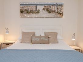 A bedroom with a bed and bedside lamps at Happy Days in Scarborough