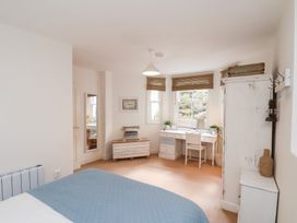 A bedroom with a bed and desk at Happy Days in Scarborough