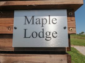 A sign displaying Maple Lodge located in Whitby