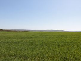 A green field with hills in the background at Maple Lodge in Whitby