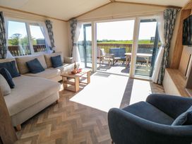 A living room with a sofa and coffee table at Fir Lodge in Whitby