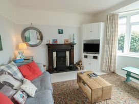 A living room with a fireplace and a coffee table at Gorse Hill in 