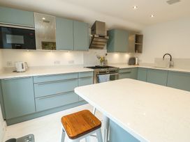 A kitchen with blue cabinets and a countertop at Gorse Hill in 