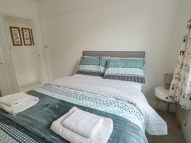 A bedroom with a bed and nightstand at Gorse Hill