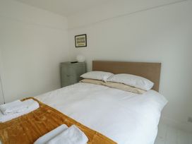 A bedroom with a bed and cabinet at Gorse Hill 