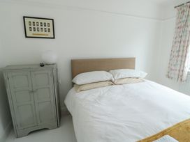 A bedroom with a bed and wardrobe at Gorse Hill 