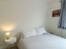 A bedroom with a bed and bedside table at Gorse Hill 