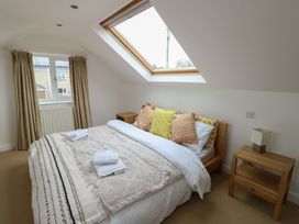 A bedroom with a bed and window at Gorse Hill 