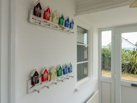 A sunroom with decorative small houses on the wall at Gorse Hill