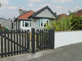 A house with a fence and gate at Gorse Hill 