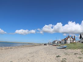 A beach with boats and houses at Gorse Hill in Rhosneigr