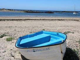 A boat on the beach near the water at Gorse Hill Rhosneigr