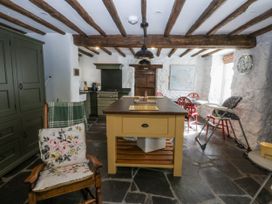 A kitchen with an island and cooking range at Tyddyn Iolyn in Benllech