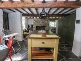 A kitchen with a wooden island in Tyddyn Iolyn Benllech