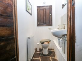 A bathroom with a toilet and sink at Tyddyn Iolyn in Benllech