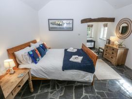 A bedroom with a bed and a chest of drawers at Tyddyn Iolyn in Benllech