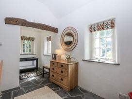 An indoor space with a chest of drawers and windows at Tyddyn Iolyn in Benllech