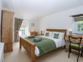 A bedroom with a bed and desk at Tyddyn Iolyn in Benllech