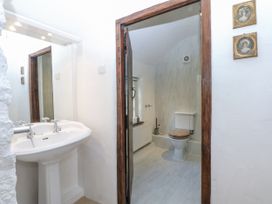 A bathroom with a sink and toilet at Tyddyn Iolyn in Benllech