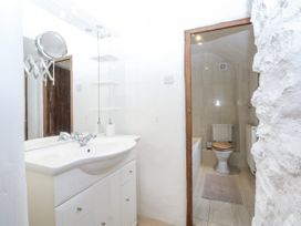 A bathroom with a sink and a toilet at Tyddyn Iolyn Benllech