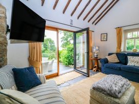 A living room with a door leading outside at Tyddyn Iolyn in Benllech