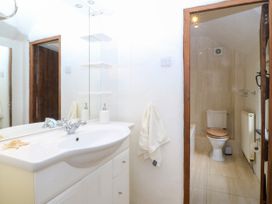 A bathroom with a sink and toilet at Tyddyn Iolyn in Benllech