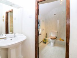 A bathroom with a sink and toilet at Tyddyn Iolyn in Benllech