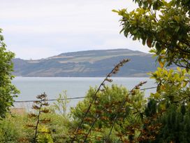 View of water and land with trees at Tyddyn Iolyn in Benllech